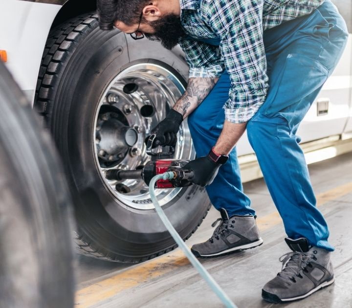 Mechanic doing repairs and maintenance on a charter bus