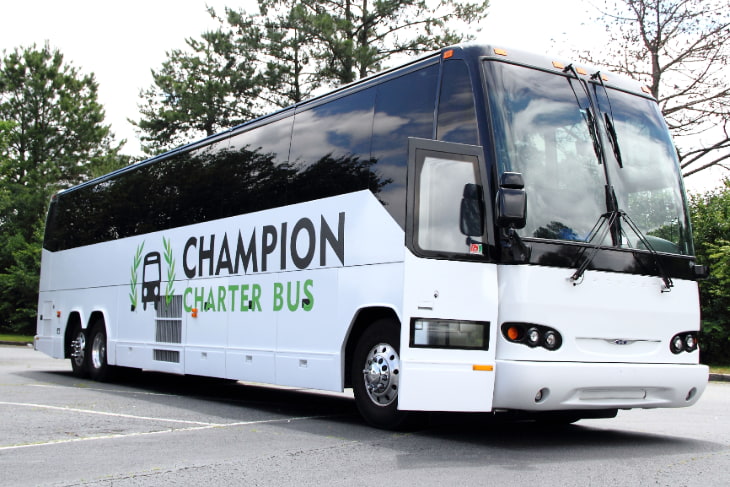 a plain white charter bus with the champion charter bus logo