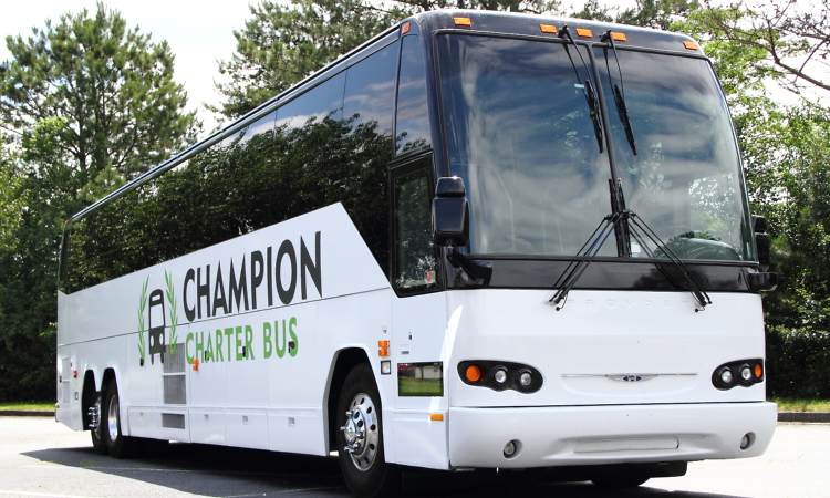 A branded Champion Charter Bus motorcoach in a parking lot