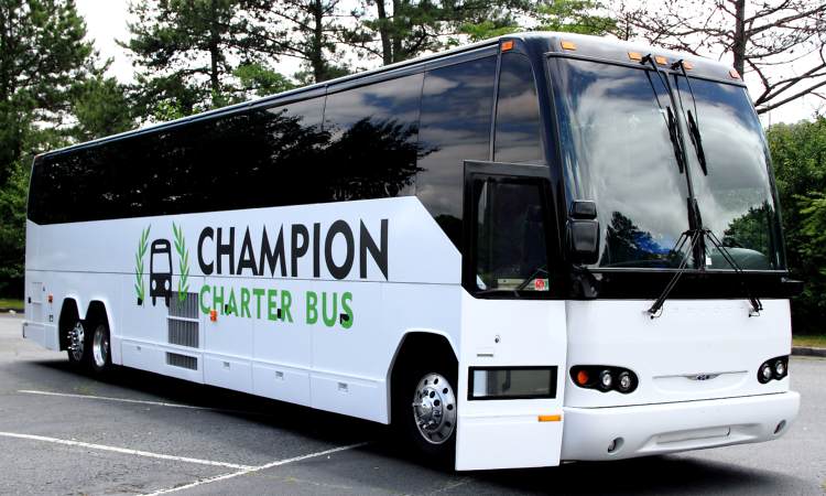 A branded Champion Charter Bus motorcoach in a parking lot