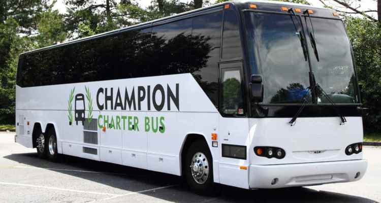 A branded Champion Charter Bus motorcoach in a parking lot