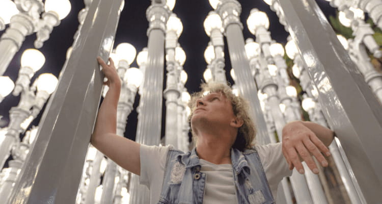 a man admires the 'urban lights' display at the los angeles county museum of art