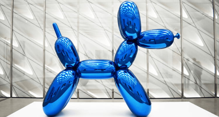 a blue metallic sculpture resembling a twist-balloon dog