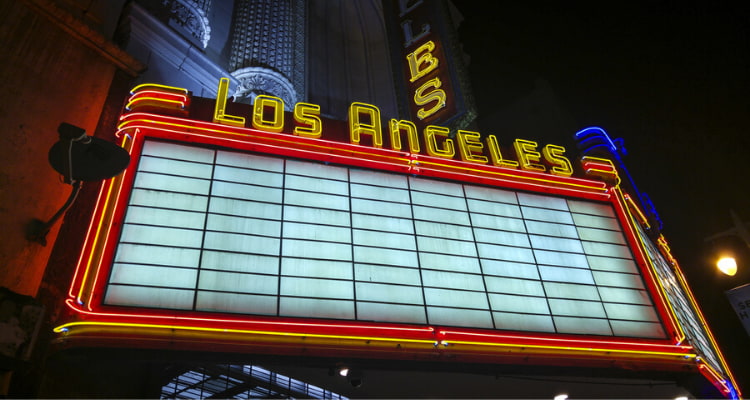 a neon movie sign that says 